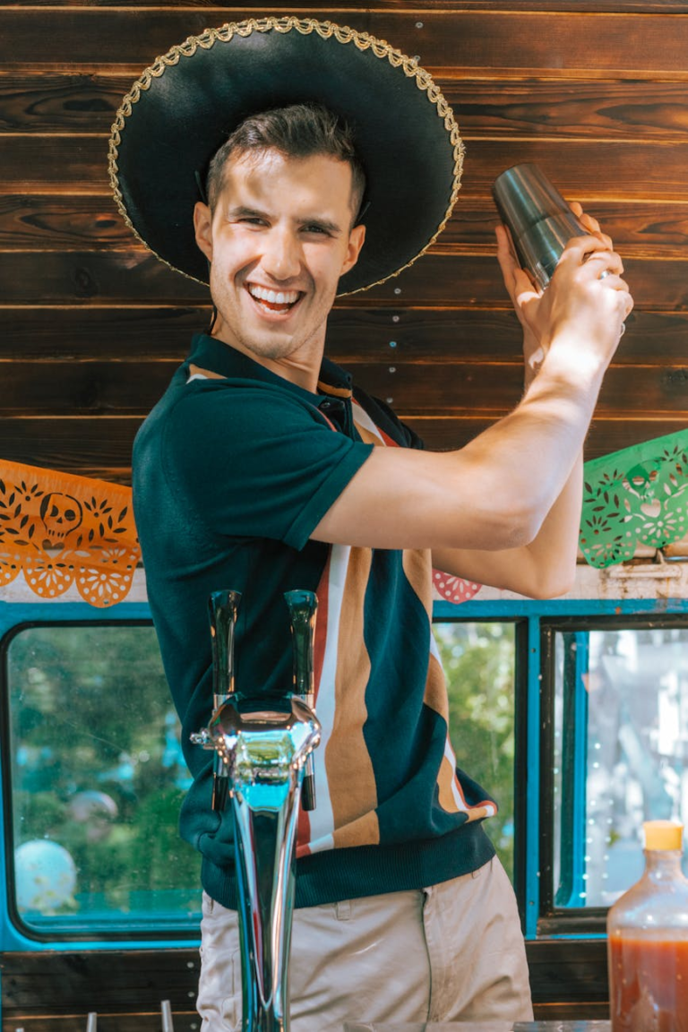 a man in black polo shirt bartending