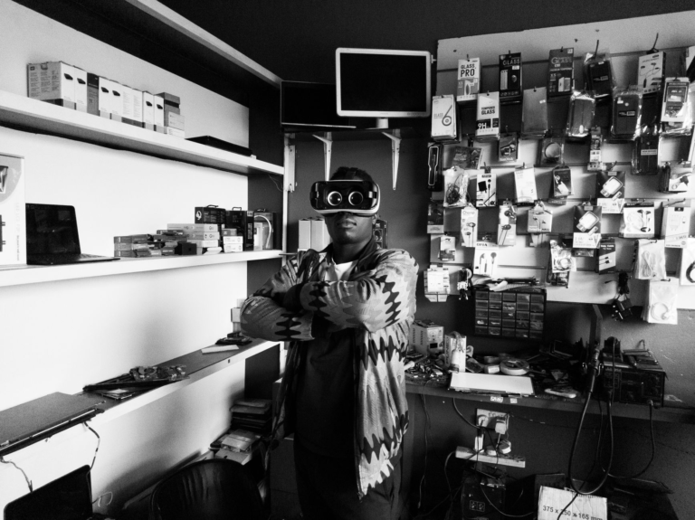 black man in vr goggles in electronics store