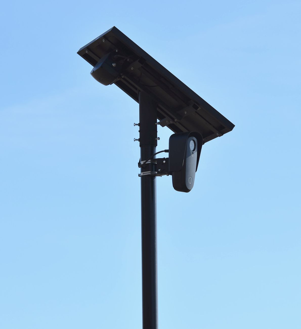 solar powered surveillance camera in blue sky